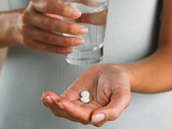 Woman Preparing to Take Pills